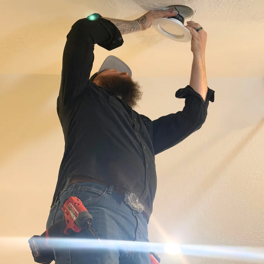 Electrician installing an indoor ceiling light
